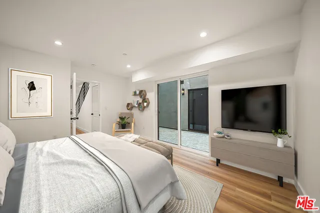 a bedroom with a bed and a flat screen tv