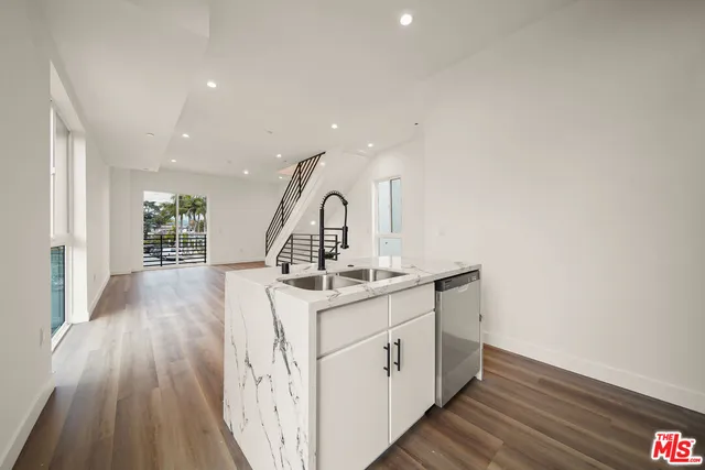 a view of kitchen with sink and wooden floor