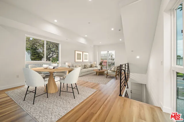 a dining room with furniture and a wooden floor