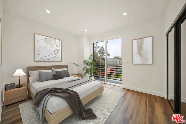 a bedroom with a bed and a painting on the wall