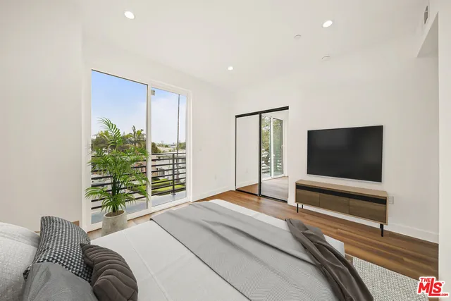 a bedroom with furniture and a flat screen tv