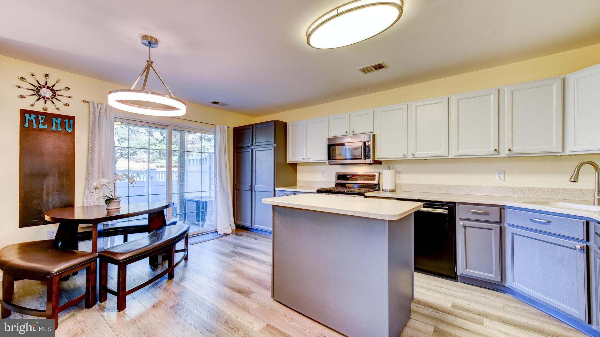 104 Coburn Road Pennington, NJ 08534 - Photo 15 of 40 a kitchen with stainless steel appliances granite countertop a stove top oven a sink dishwasher and white cabinets with wooden floor