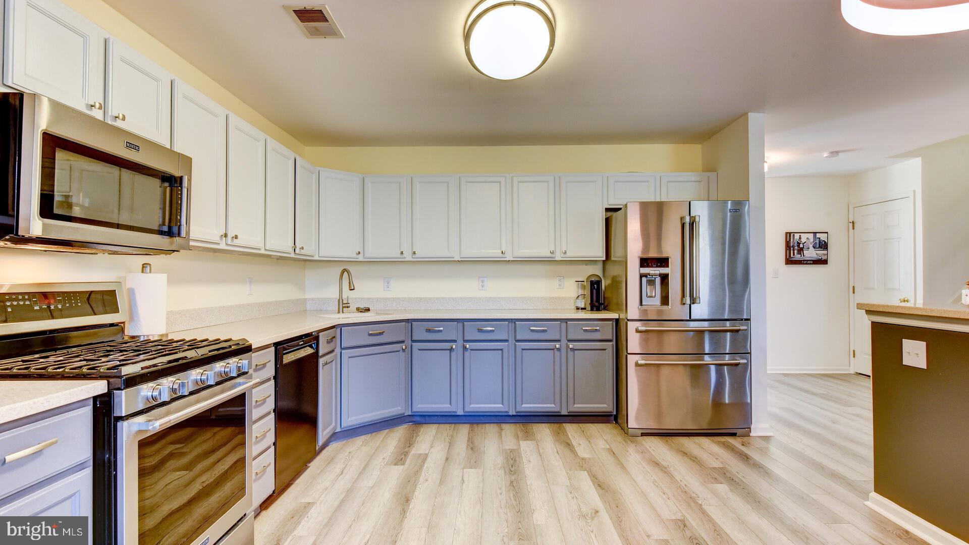 104 Coburn Road Pennington, NJ 08534 - Photo 19 of 40 a kitchen with stainless steel appliances granite countertop a stove top oven a sink and a refrigerator