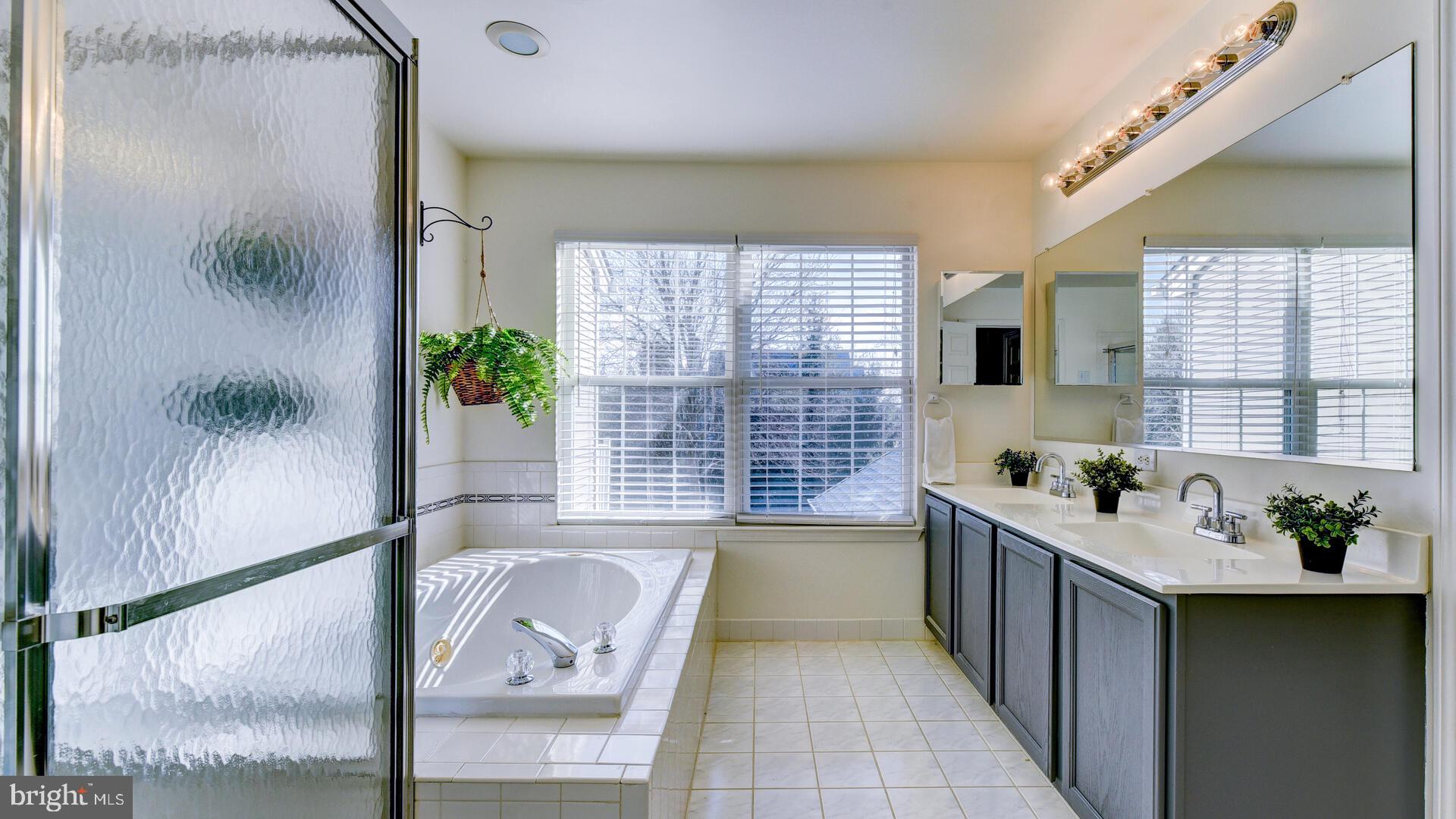 104 Coburn Road Pennington, NJ 08534 - Photo 27 of 40 a bathroom with a bathtub a sink and a window