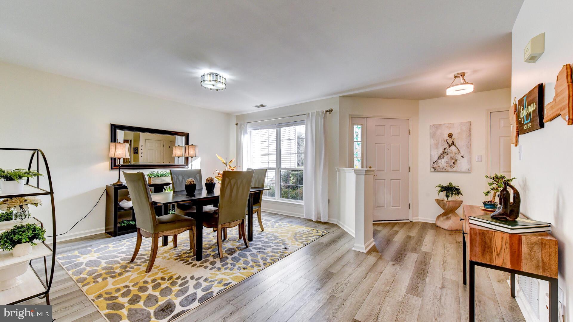 104 Coburn Road Pennington, NJ 08534 - Photo 4 of 40 a view of a dining room with furniture and wooden floor