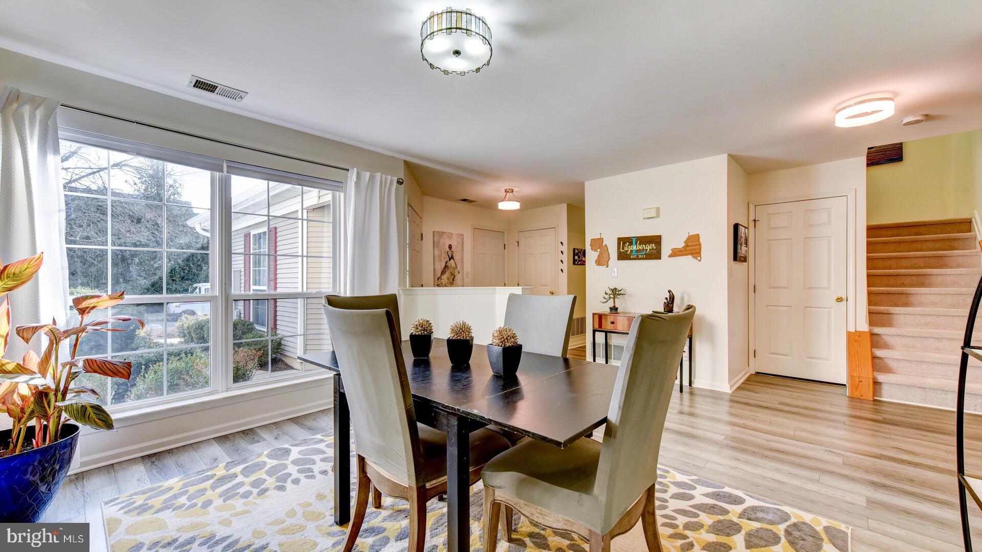 104 Coburn Road Pennington, NJ 08534 - Photo 7 of 40 a view of a dining room with furniture window and wooden floor