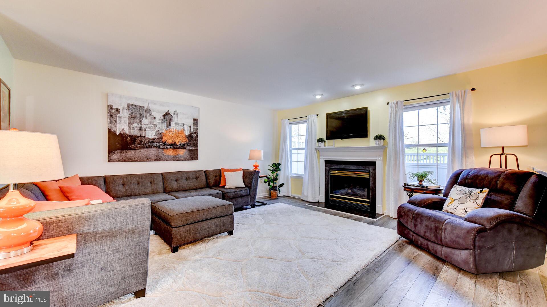 104 Coburn Road Pennington, NJ 08534 - Photo 9 of 40 a living room with furniture a flat screen tv and a fireplace
