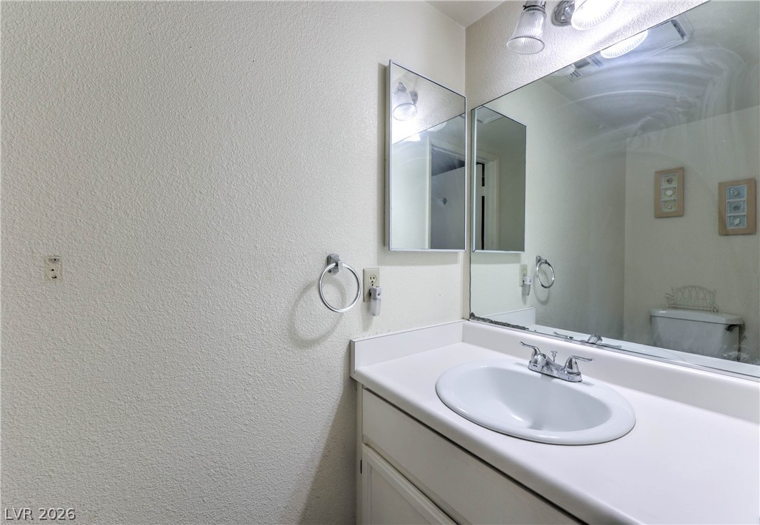 581 Carleton Drive Henderson, NV 89014 - Photo 13 of 37 A classic bathroom vanity with a full-width mirror offers daily convenience.