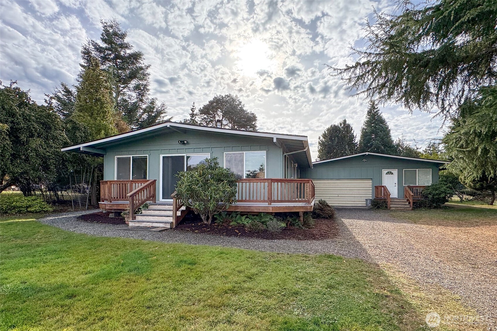 a view of a house with a yard and sitting area
