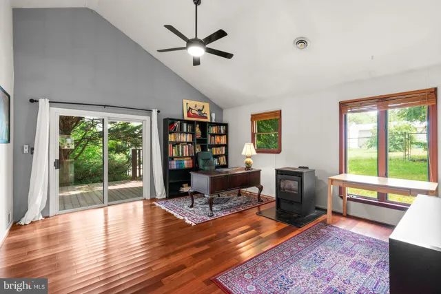 a living room with furniture a window and a flat screen tv