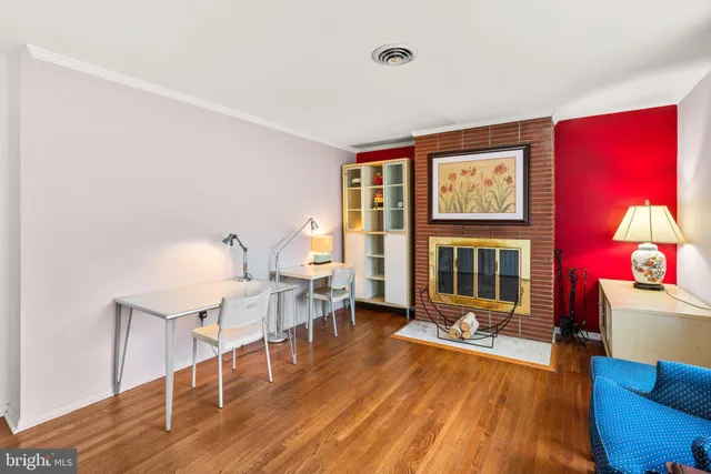 a view of a room with wooden floor and lounge chair