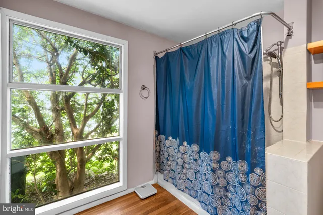 a bathroom with a bathtub and a shower