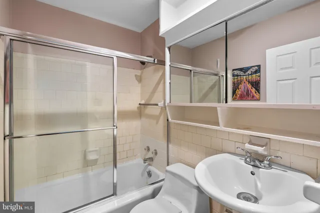 a bathroom with a shower and a sink