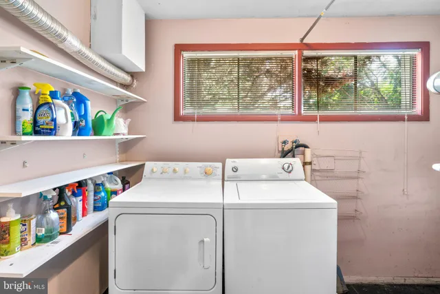 a view of a yard with a small deck and wooden fence