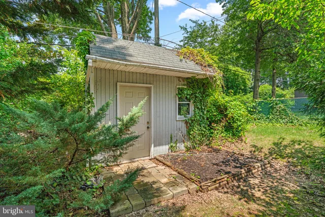 a backyard of a house with outdoor seating and trees