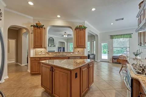 a kitchen with sink stove and refrigerator