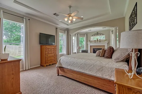 a bedroom with a large bed and a flat tv screen