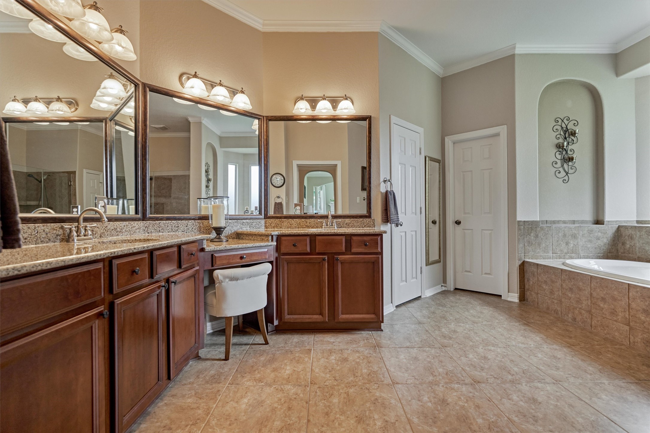 2500 Eagle Post Drive Conroe, TX 77304 - Photo 22 of 50 Gorgeous primary bath features expansive granite vanity with seated prep area, dual sinks, impressive storage, dual closets + linen closet , crown molding and decorative art niches!