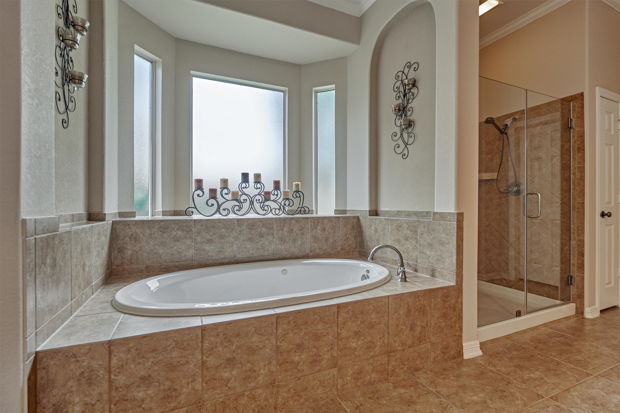 2500 Eagle Post Drive Conroe, TX 77304 - Photo 23 of 50 Oversized tub with frosted glass bay window is a welcome sight after a long day! Separate stall shower with seamless glass surround offers built in shelf for added convenience.