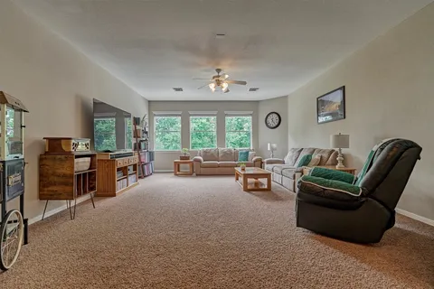 a living room with furniture and a chandelier