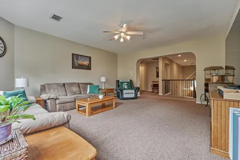 a living room with furniture and a chandelier