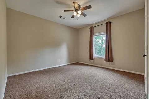 a view of room with window and ceiling fan