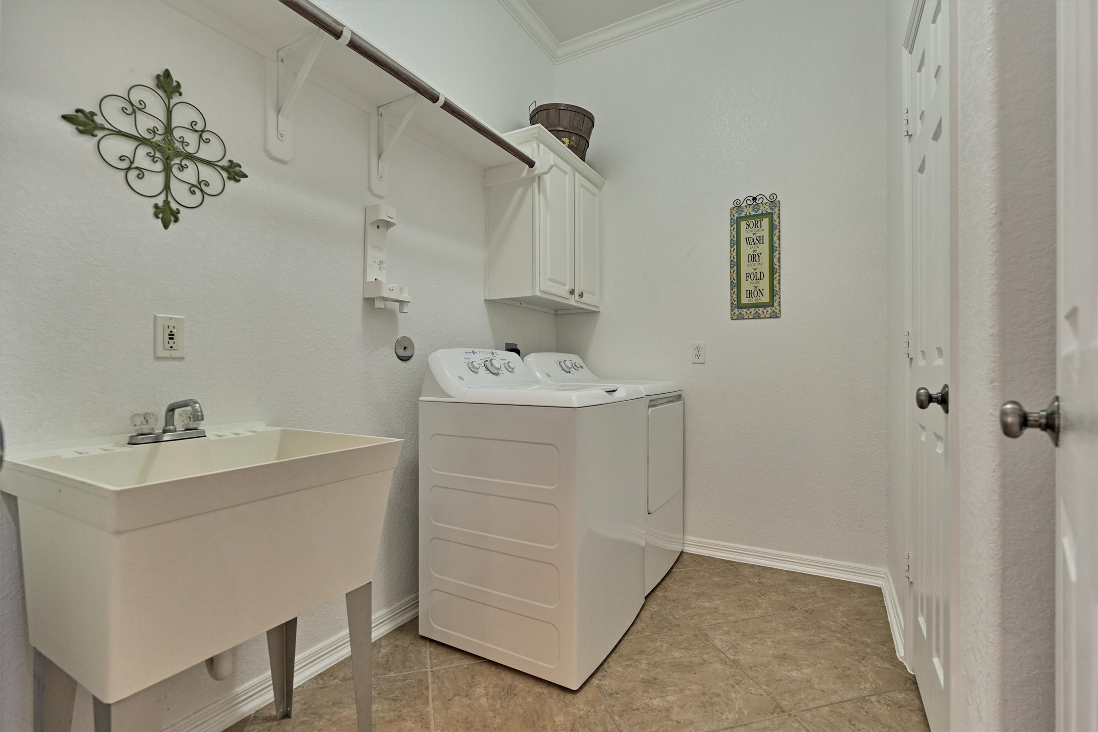 2500 Eagle Post Drive Conroe, TX 77304 - Photo 36 of 50 Spacious utility room with sink and smart storage solutions.