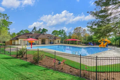 a front view of a house with yard and green space