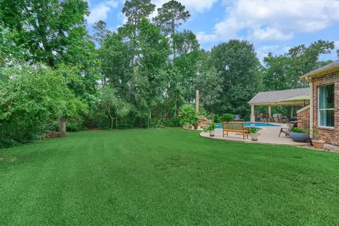 a view of a house with swimming pool and sitting area