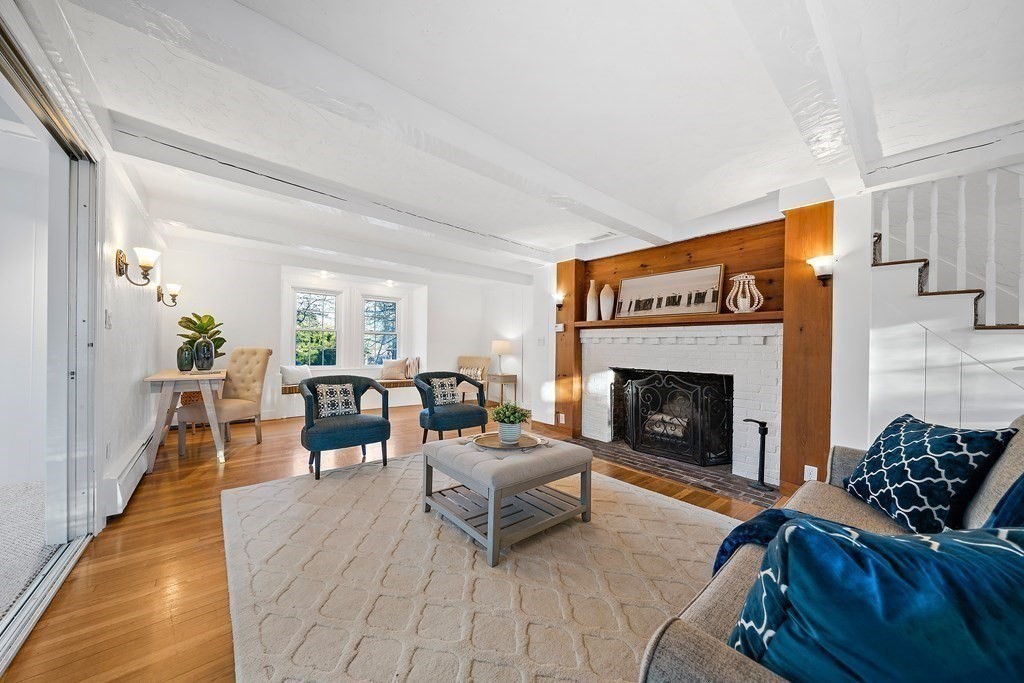 125 Driftway Scituate, MA 02066 - Photo 11 of 35 a living room with furniture and a fireplace