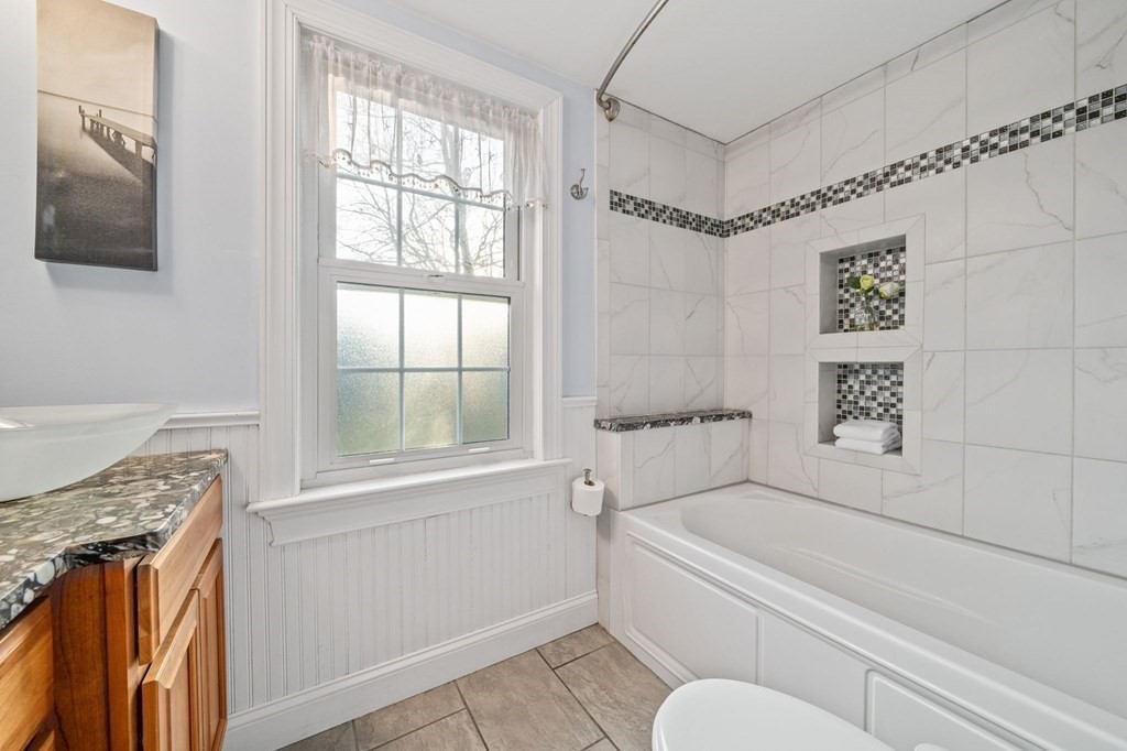 125 Driftway Scituate, MA 02066 - Photo 13 of 35 a bathroom with a tub a sink and a window