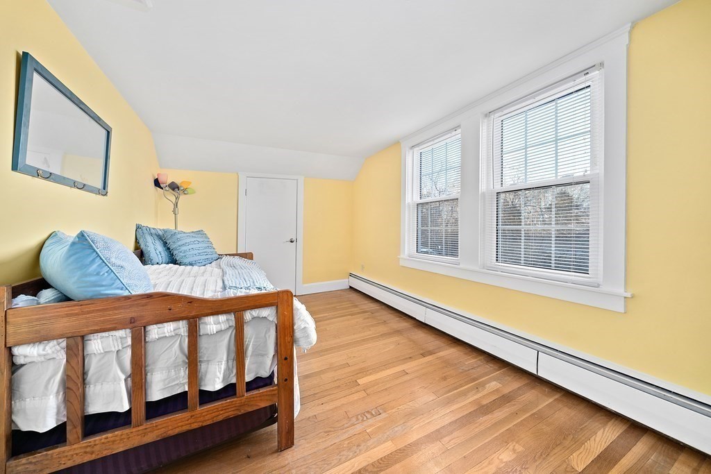 125 Driftway Scituate, MA 02066 - Photo 18 of 35 a bedroom with furniture and wooden floor