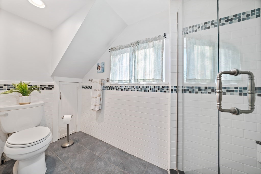 125 Driftway Scituate, MA 02066 - Photo 19 of 35 a bathroom with a granite countertop sink a toilet and shower