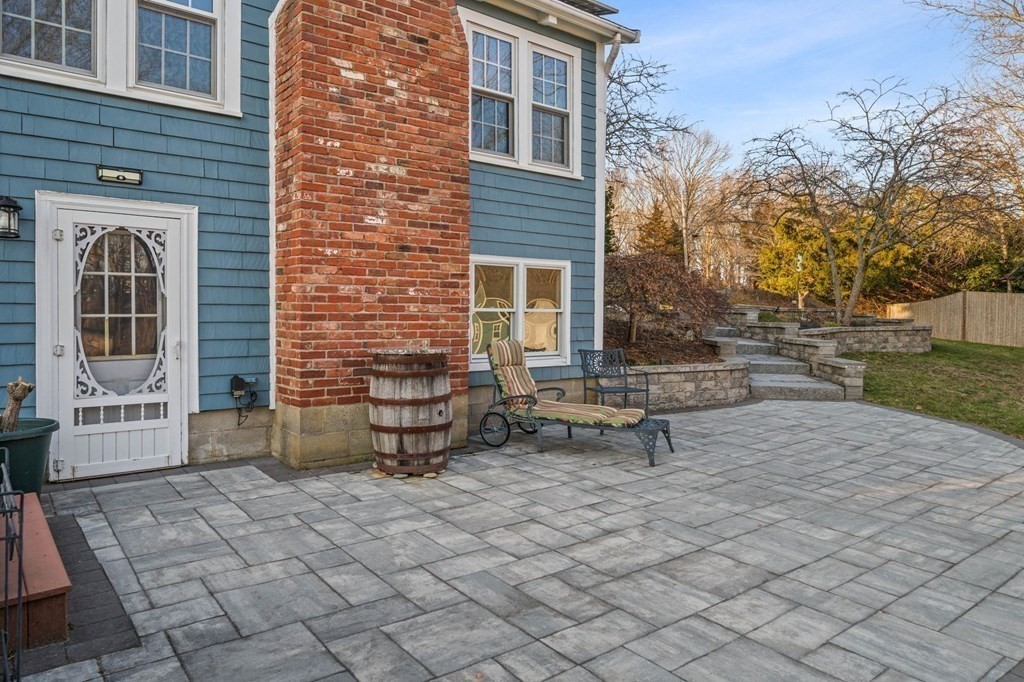 125 Driftway Scituate, MA 02066 - Photo 23 of 35 a view of a brick house with a bench in front of it