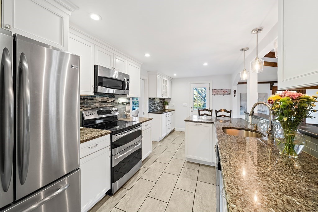 125 Driftway Scituate, MA 02066 - Photo 5 of 35 a kitchen with a refrigerator and a stove top oven