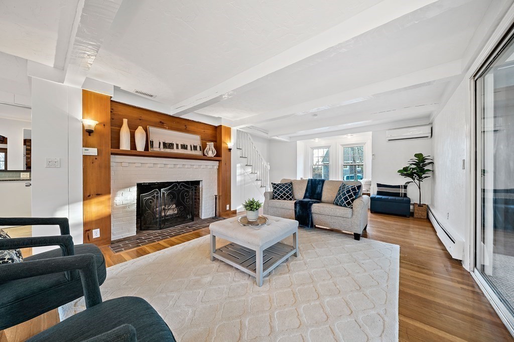 125 Driftway Scituate, MA 02066 - Photo 10 of 35 a living room with furniture and a fireplace