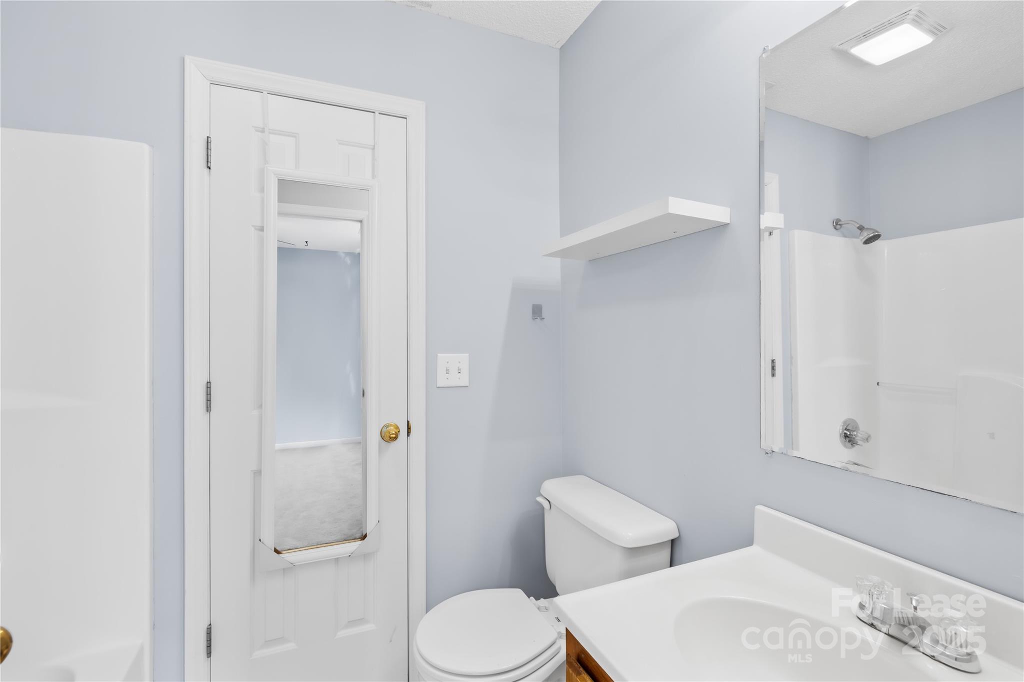 7610 Sarah Drive Denver, NC 28037 - Photo 11 of 17 a white toilet sitting next to a bathroom sink