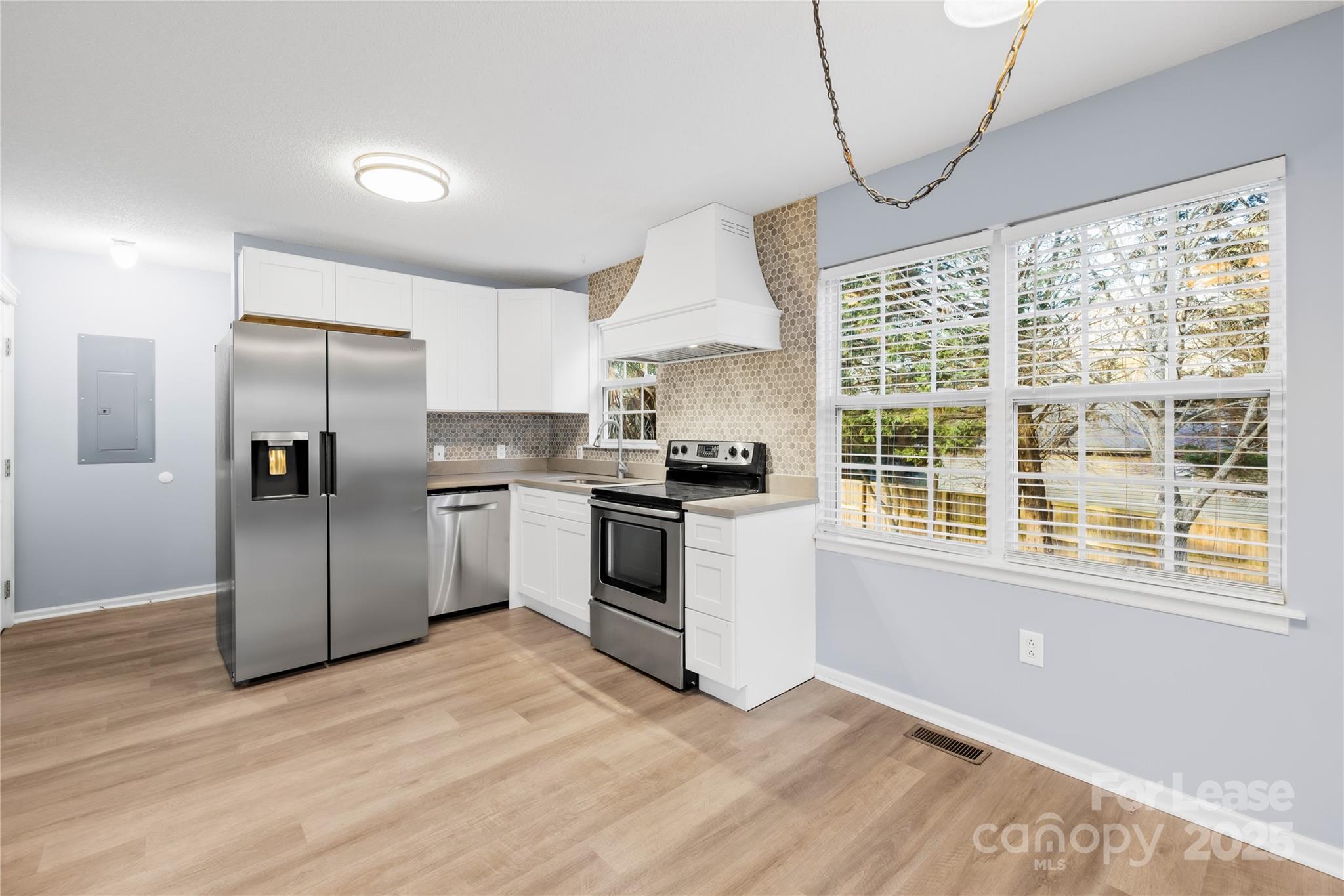 7610 Sarah Drive Denver, NC 28037 - Photo 5 of 17 a kitchen with granite countertop a stove a sink and a refrigerator