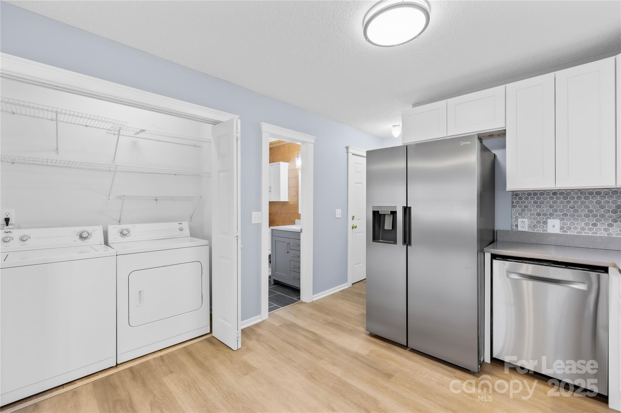 7610 Sarah Drive Denver, NC 28037 - Photo 7 of 17 a kitchen with cabinets and stainless steel appliances