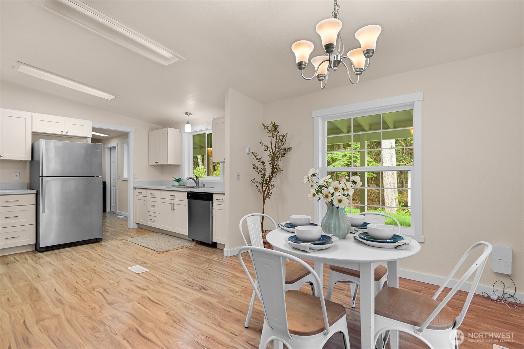 6159 Cedar Lane Maple Falls, WA 98266 - Photo 11 of 31 a kitchen with stainless steel appliances granite countertop a dining table chairs and chandelier