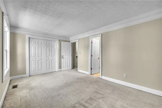 a view of an empty room and closet area