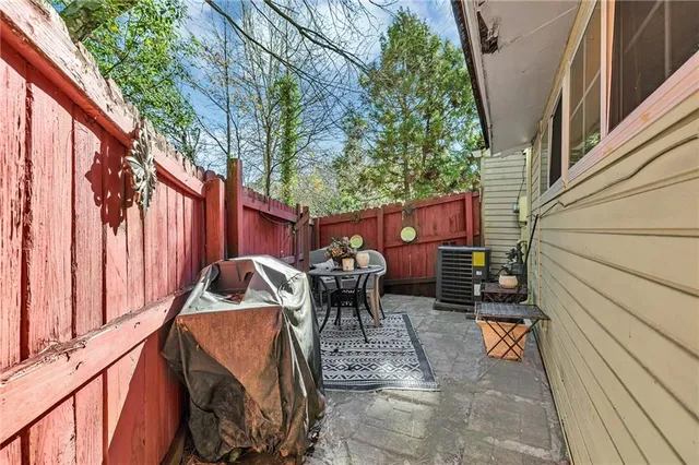 a view of backyard with outdoor seating and trees