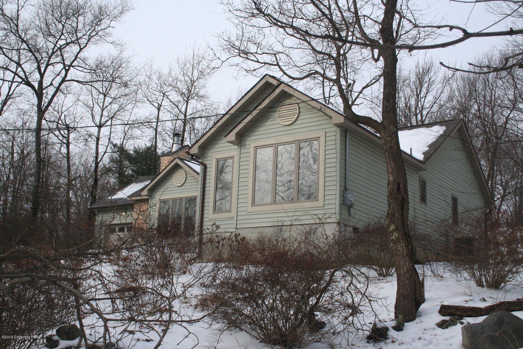 6427 Crestview Road Swiftwater, PA 18370 - Photo 3 of 16 a front view of a house with garden