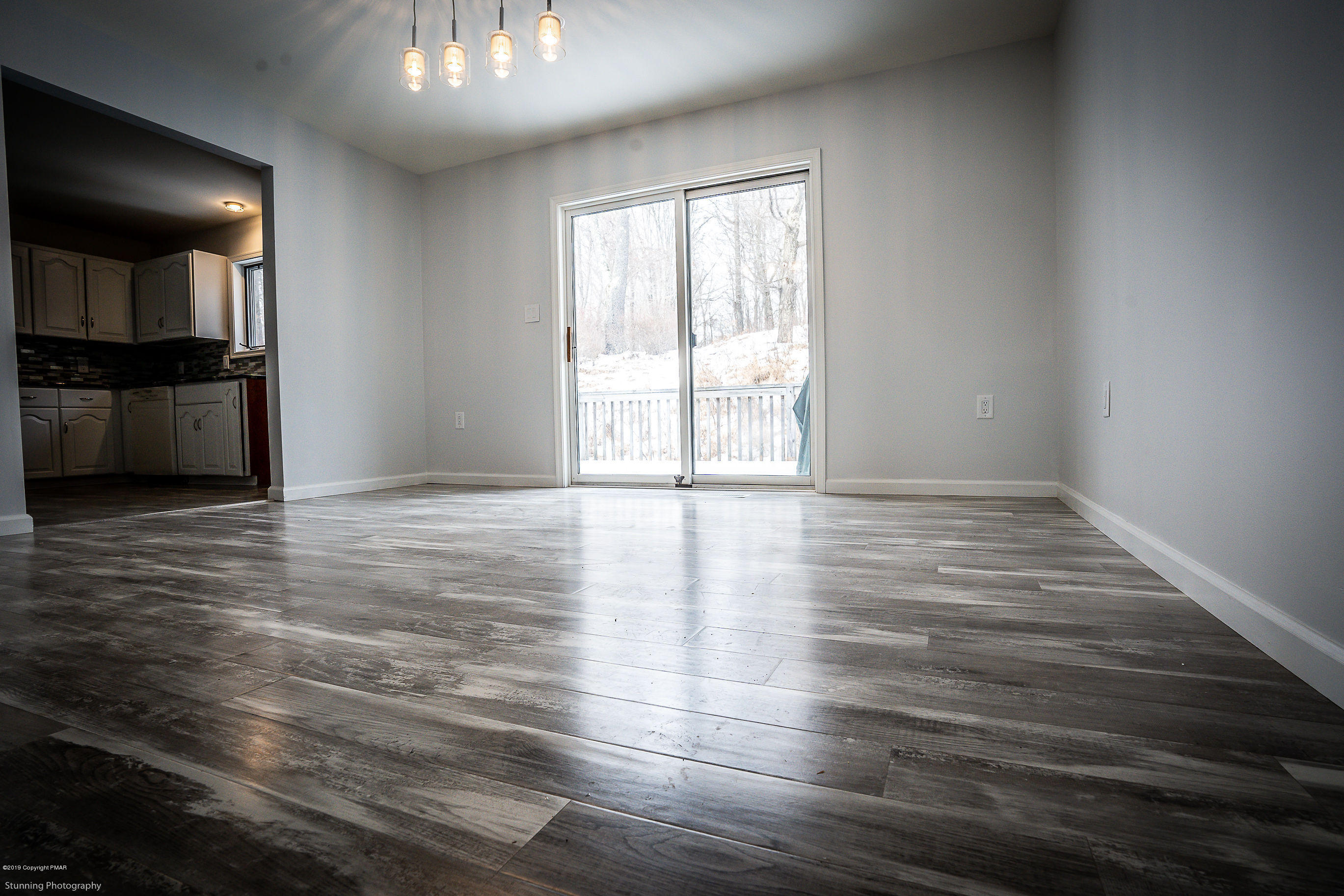 6427 Crestview Road Swiftwater, PA 18370 - Photo 6 of 16 an empty room with wooden floor and windows