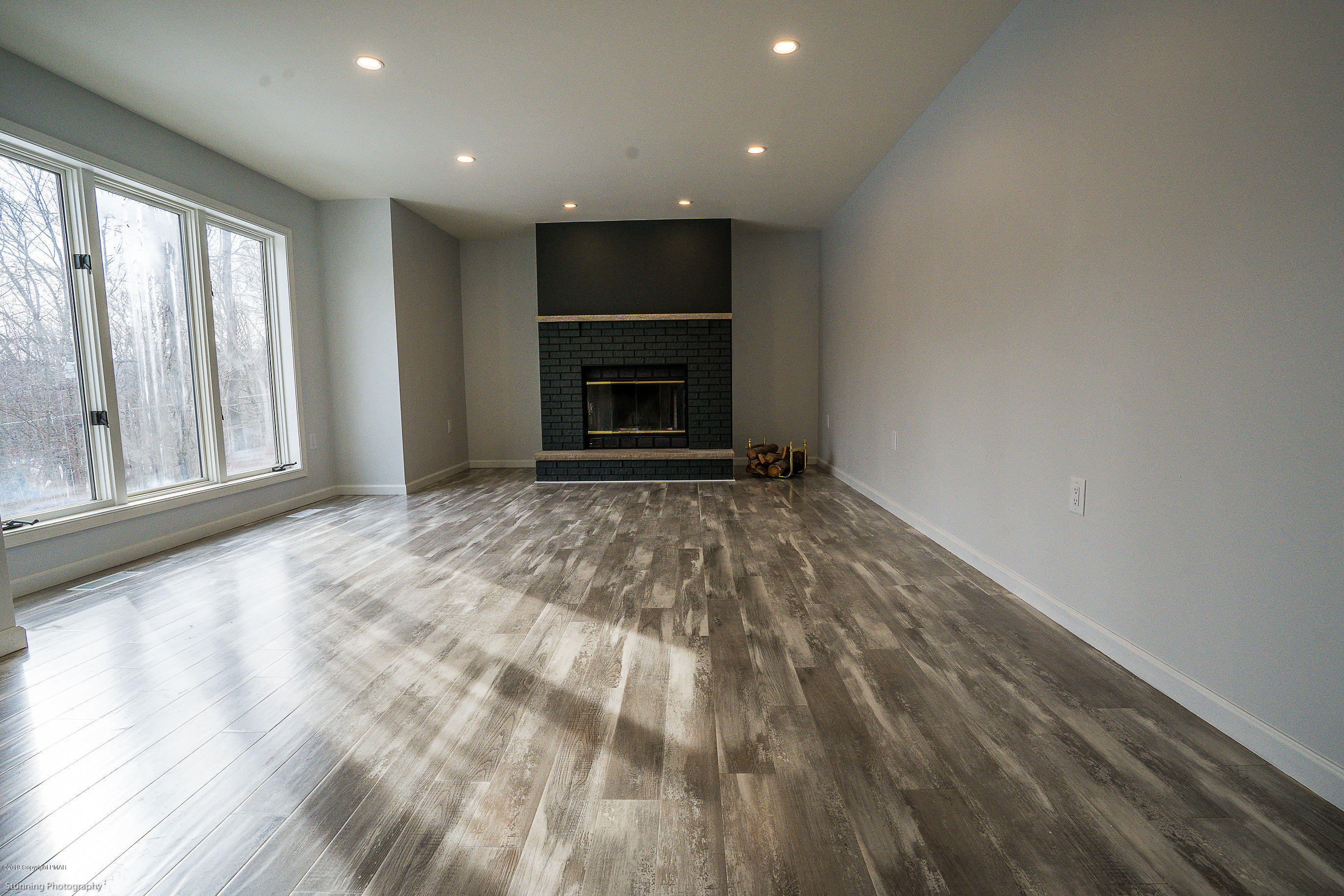 6427 Crestview Road Swiftwater, PA 18370 - Photo 7 of 16 a view of an empty room with a fireplace and a window