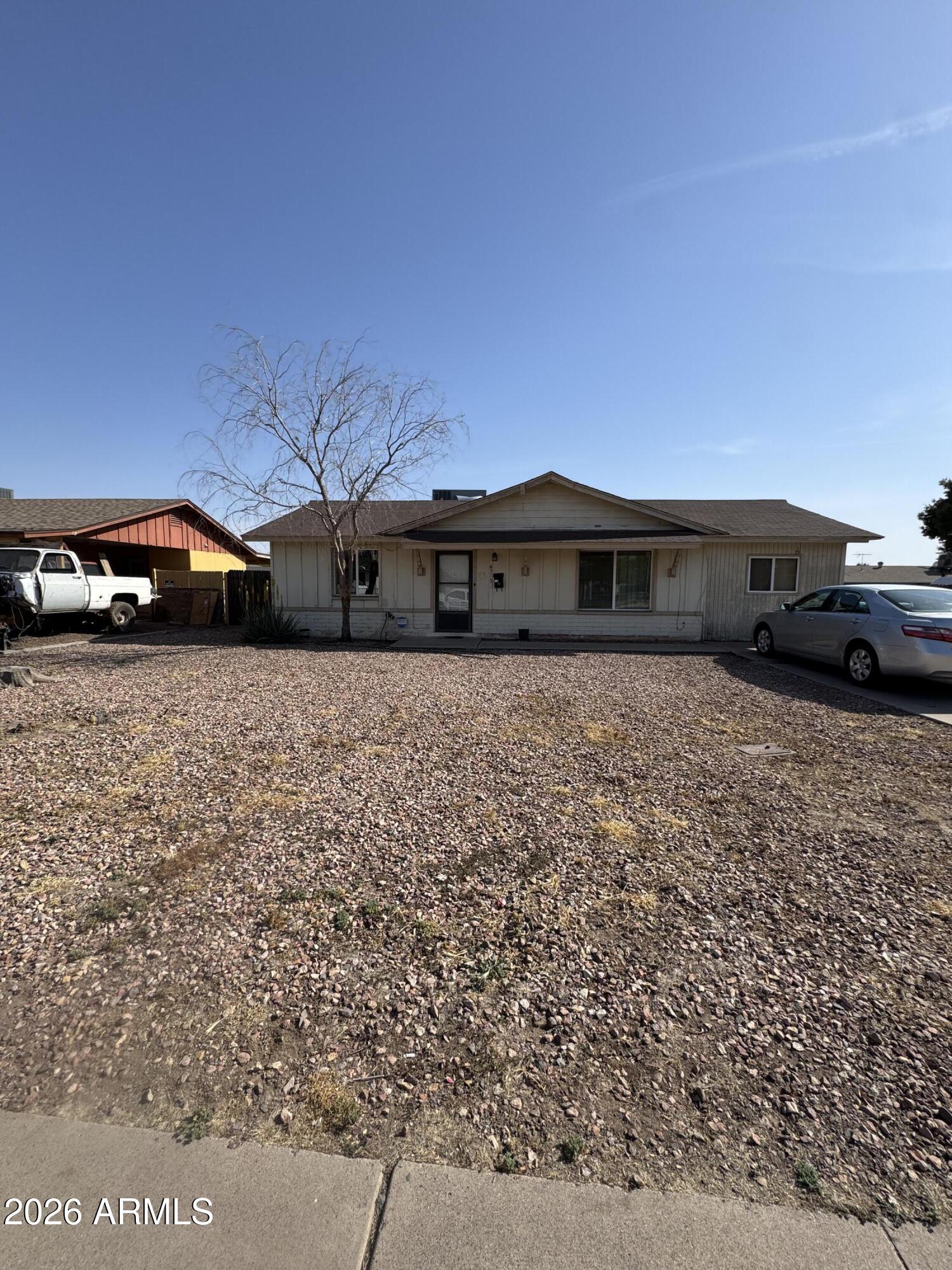 6313 West Osborn Road Phoenix, AZ 85033 - Photo 1 of 12 a view of a car parked in front of a house