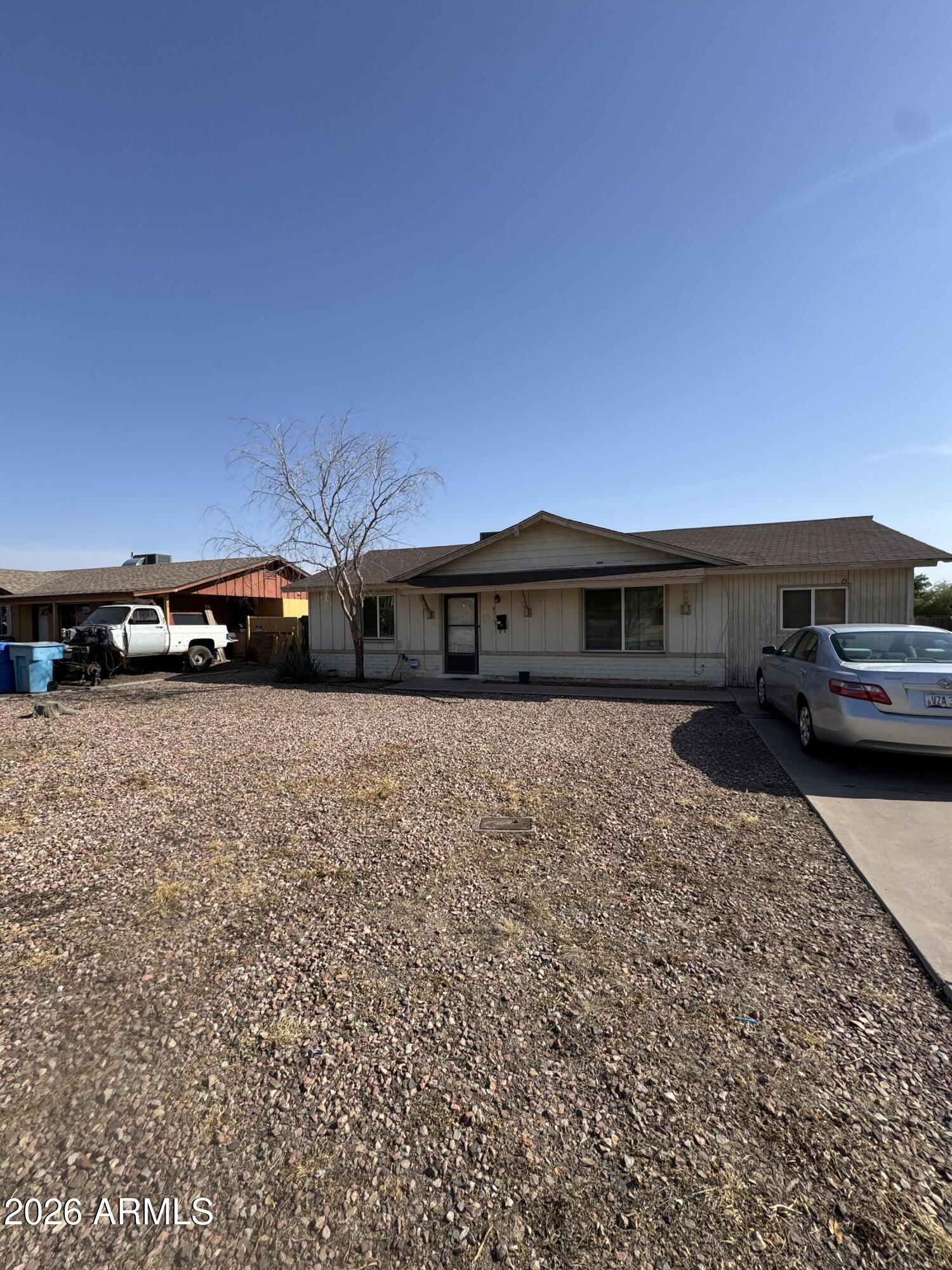 6313 West Osborn Road Phoenix, AZ 85033 - Photo 11 of 12 a front view of a house with a yard