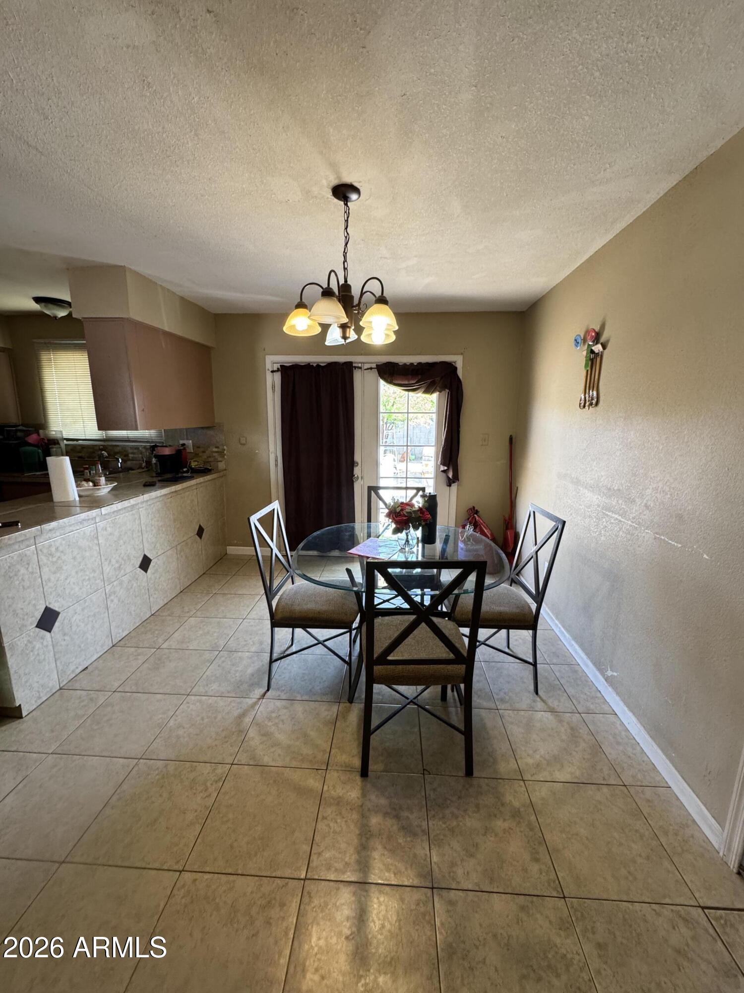 6313 West Osborn Road Phoenix, AZ 85033 - Photo 3 of 12 a view of a dining room with furniture and chandelier