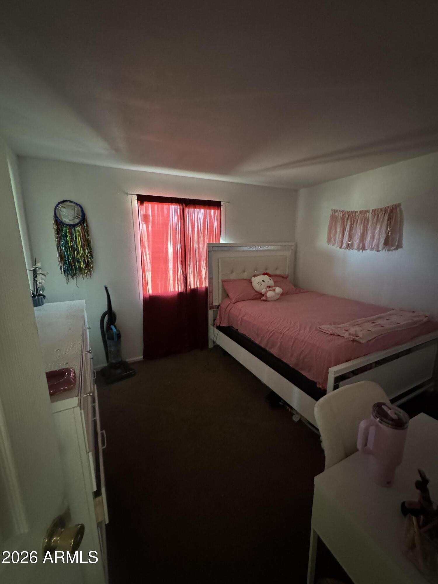 6313 West Osborn Road Phoenix, AZ 85033 - Photo 8 of 12 a bedroom with a bed and window