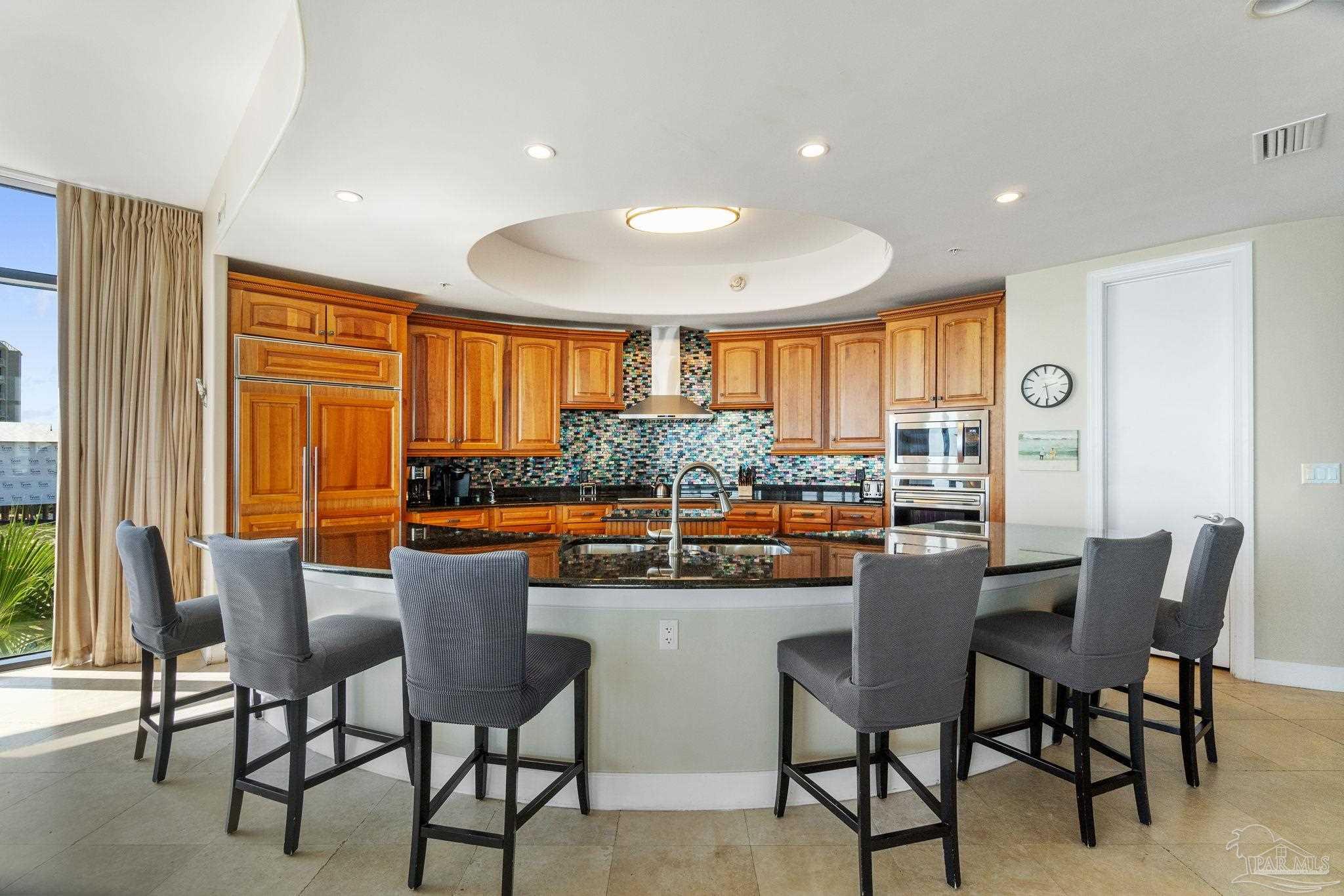 16551 Perdido Key Drive, Unit 202 Perdido Key, FL 32507 - Photo 15 of 54 a dining room with stainless steel appliances a table and chairs